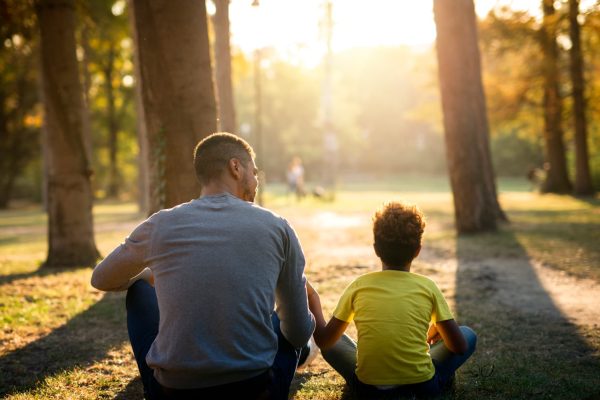 f2ather-daughter-sitting-grass-park-enjoying-sunset-together 1 (1)